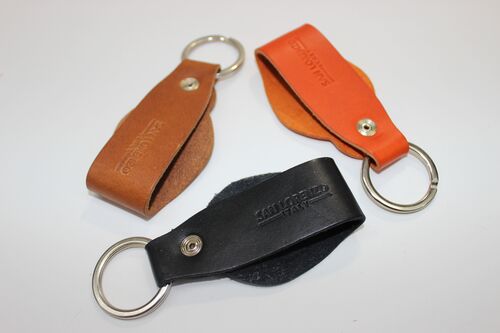 Genuine Leather Round Key Chain shown in Orange, Cognac, and Black